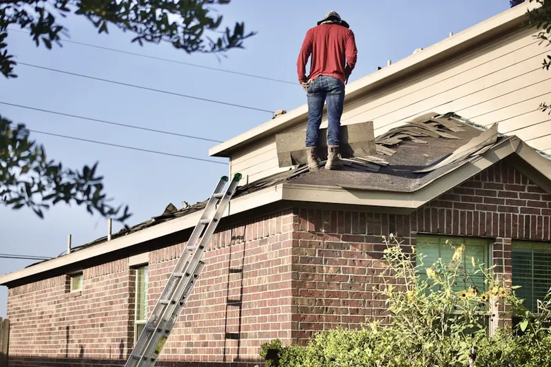 Professional roofer working on a residential roof in Meadedale